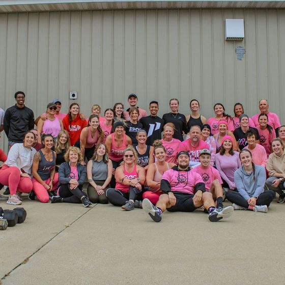 A large group of people posing for a picture in front of a building