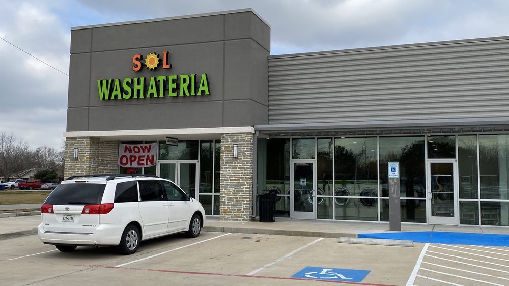 Exterior of Sol Washateria with white minivan parked out front; 