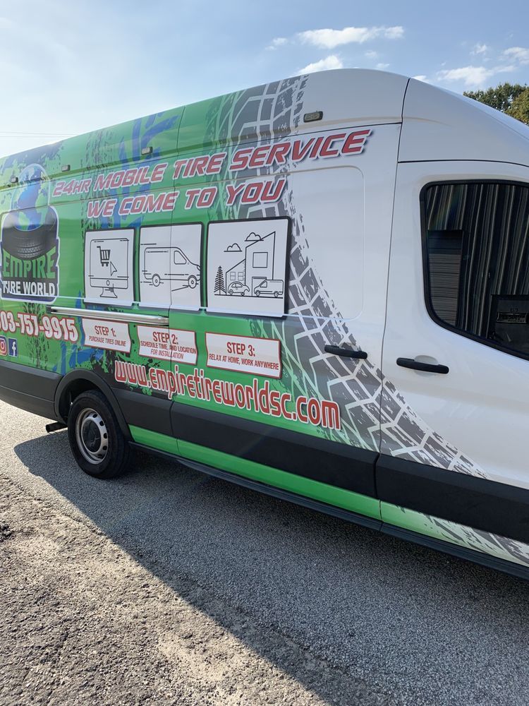 Mobile tire service van with green and white graphics parked outdoors.
