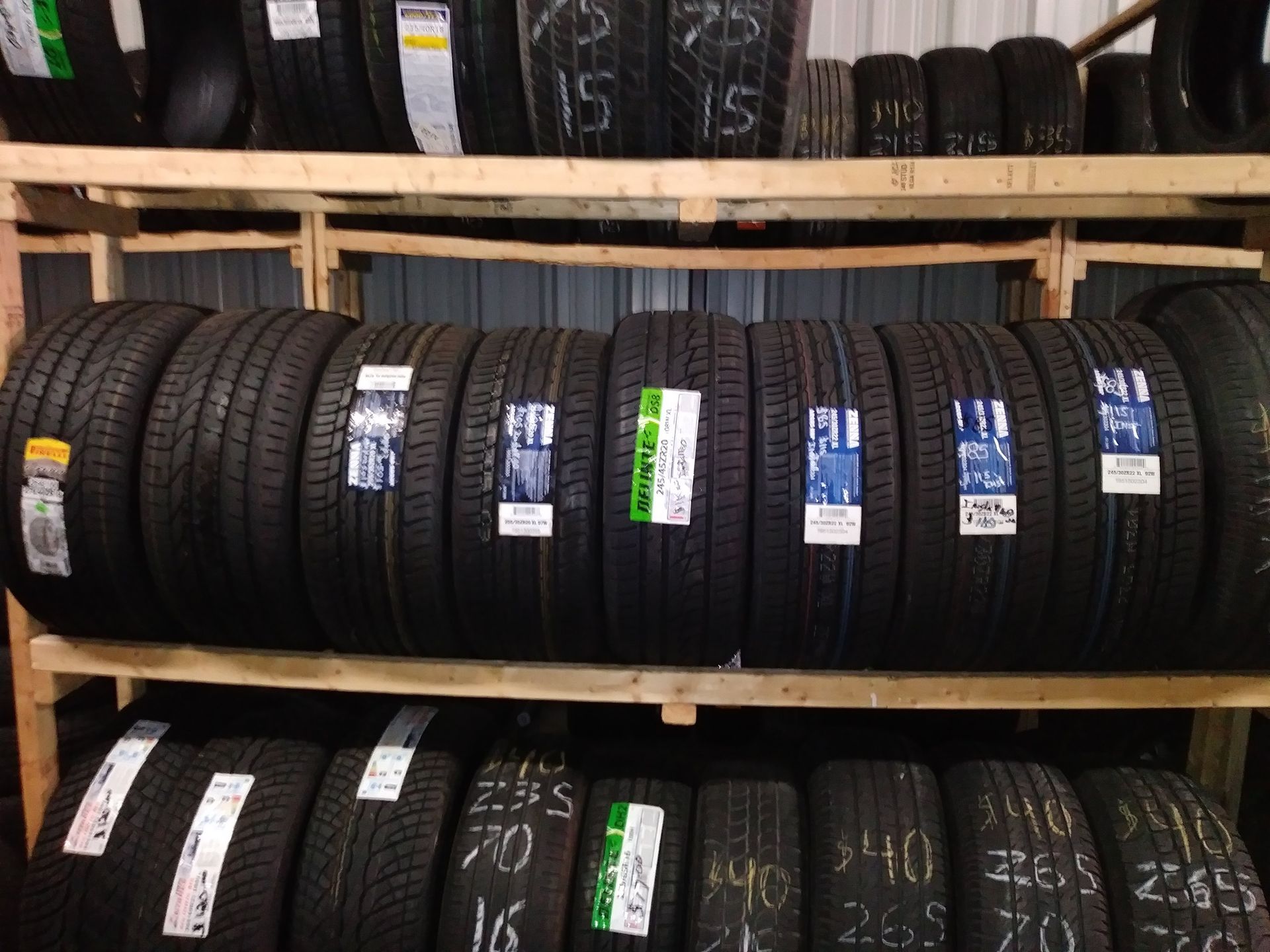 Shelves filled with various car tires displayed in a storage area.