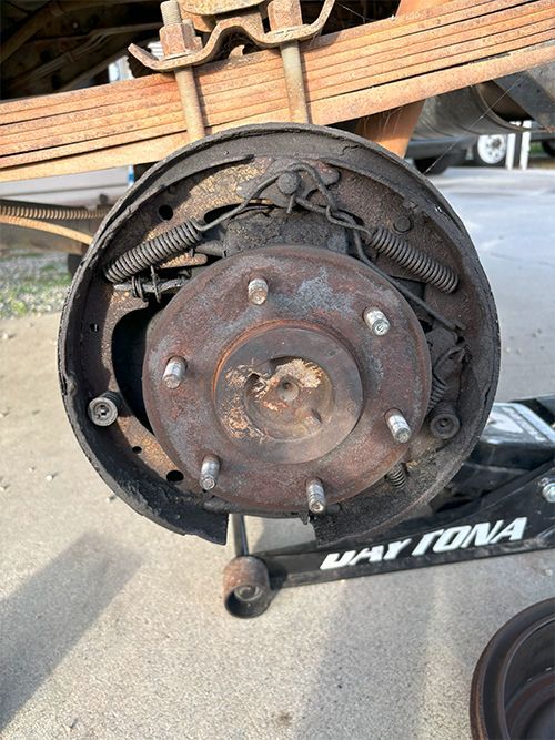 mechanic replacing a leaking brake wheel cylinder