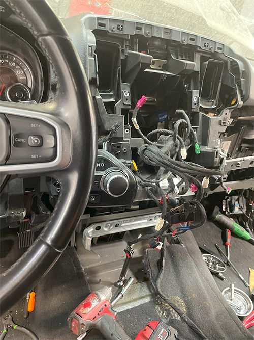 mechanic fixing a heater core on a 2020 ram truck, dash removed