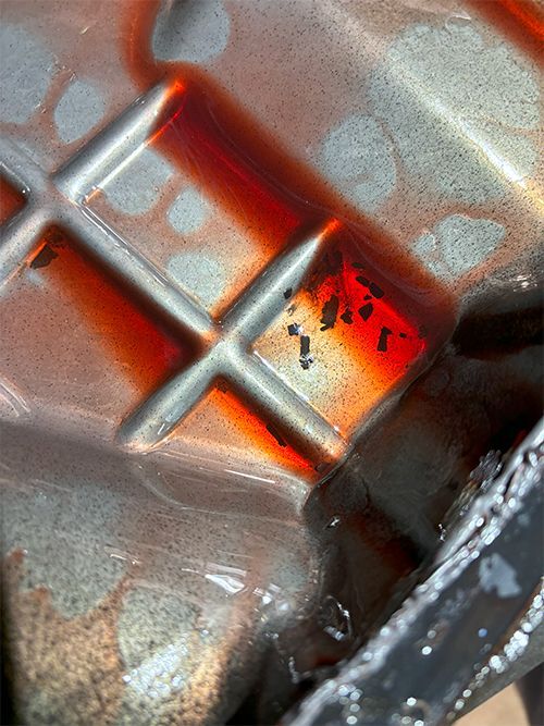 mechanic inspecting the transmission pan for clutch wear materials