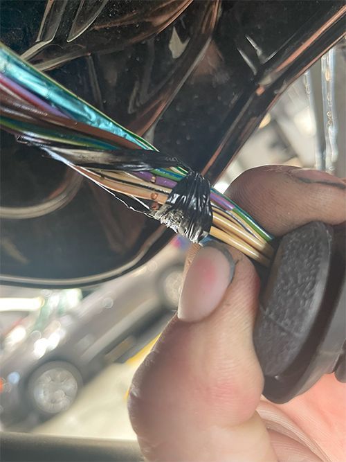 mechanic replacing a shorted rear hatch harness on a Dodge Journey