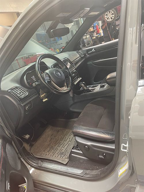 mechanic fixing an a/c evaporator, dashboard reinstalled