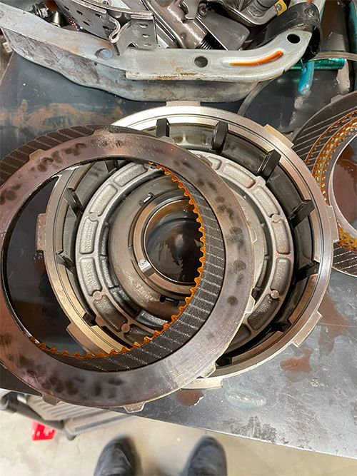 Mechanic disassembling a pulled transmission