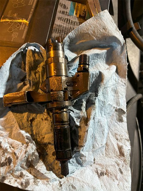 mechanic replacing an injector on a Duramax diesel truck