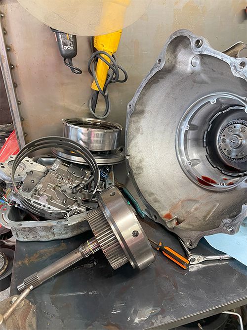 Mechanic rebuilding a transmission on a workbench