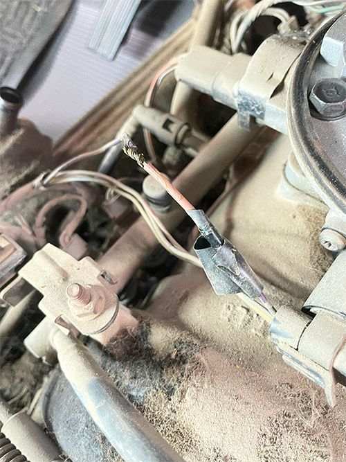 mechanic fixing a cut wiring harness