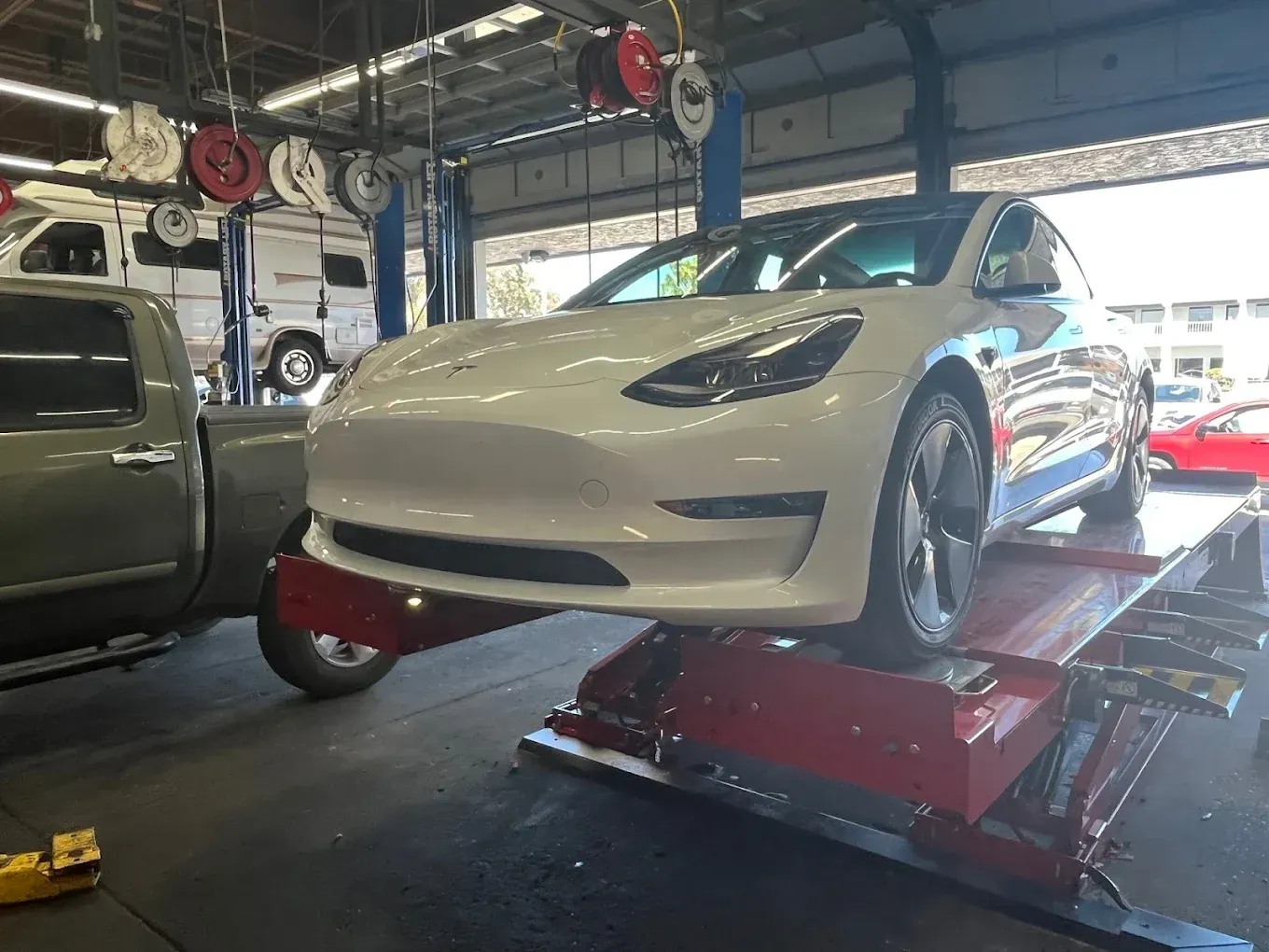 White Tesla Inside of Auto Shop | Santa Cruz Tire and Auto Care