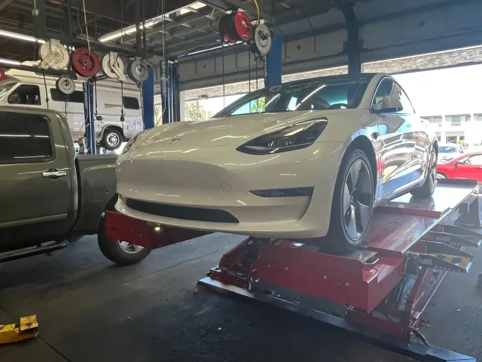 White Tesla Inside of Auto Shop | Santa Cruz Tire and Auto Care
