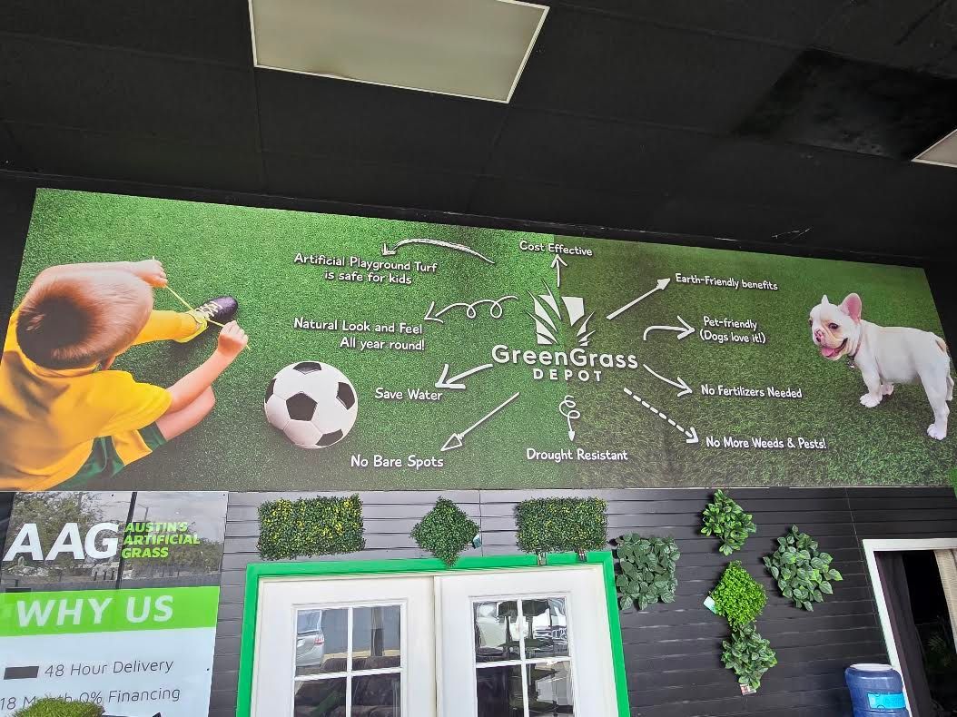 A wall with a picture of a child playing with a soccer ball and a dog.