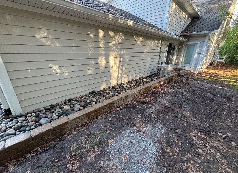 A house with a lot of rocks on the side of it.