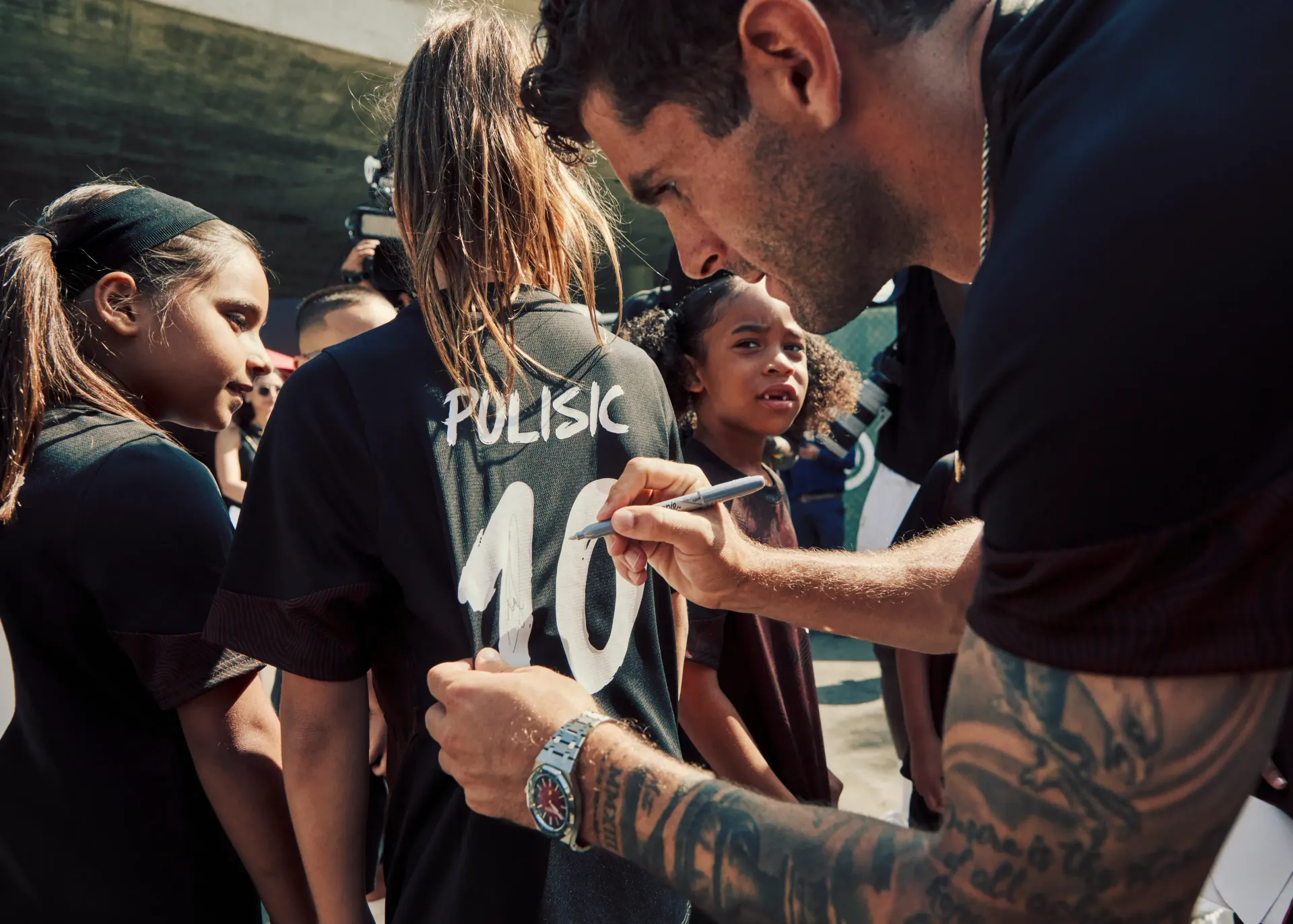 Boy kicking a soccer ball on a field. 