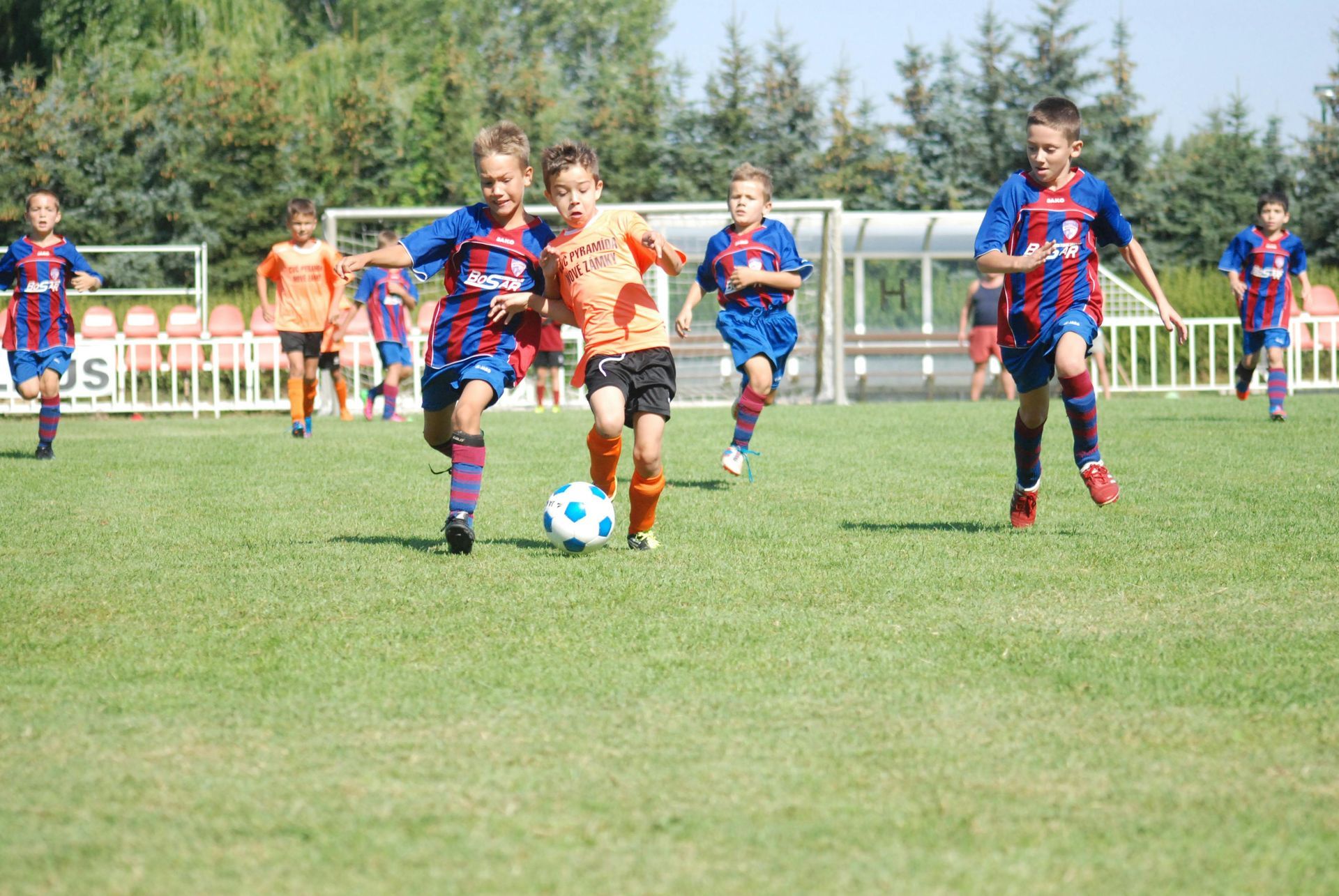 A group of young boys are playing soccer on a field.