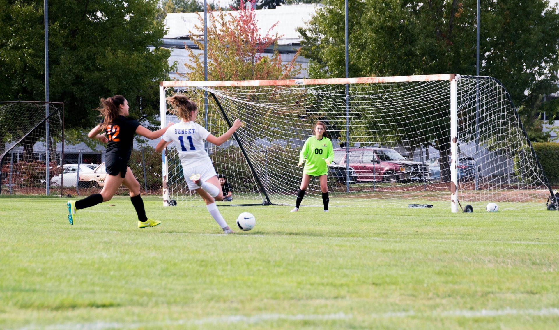 A group of girls are playing soccer on a field.