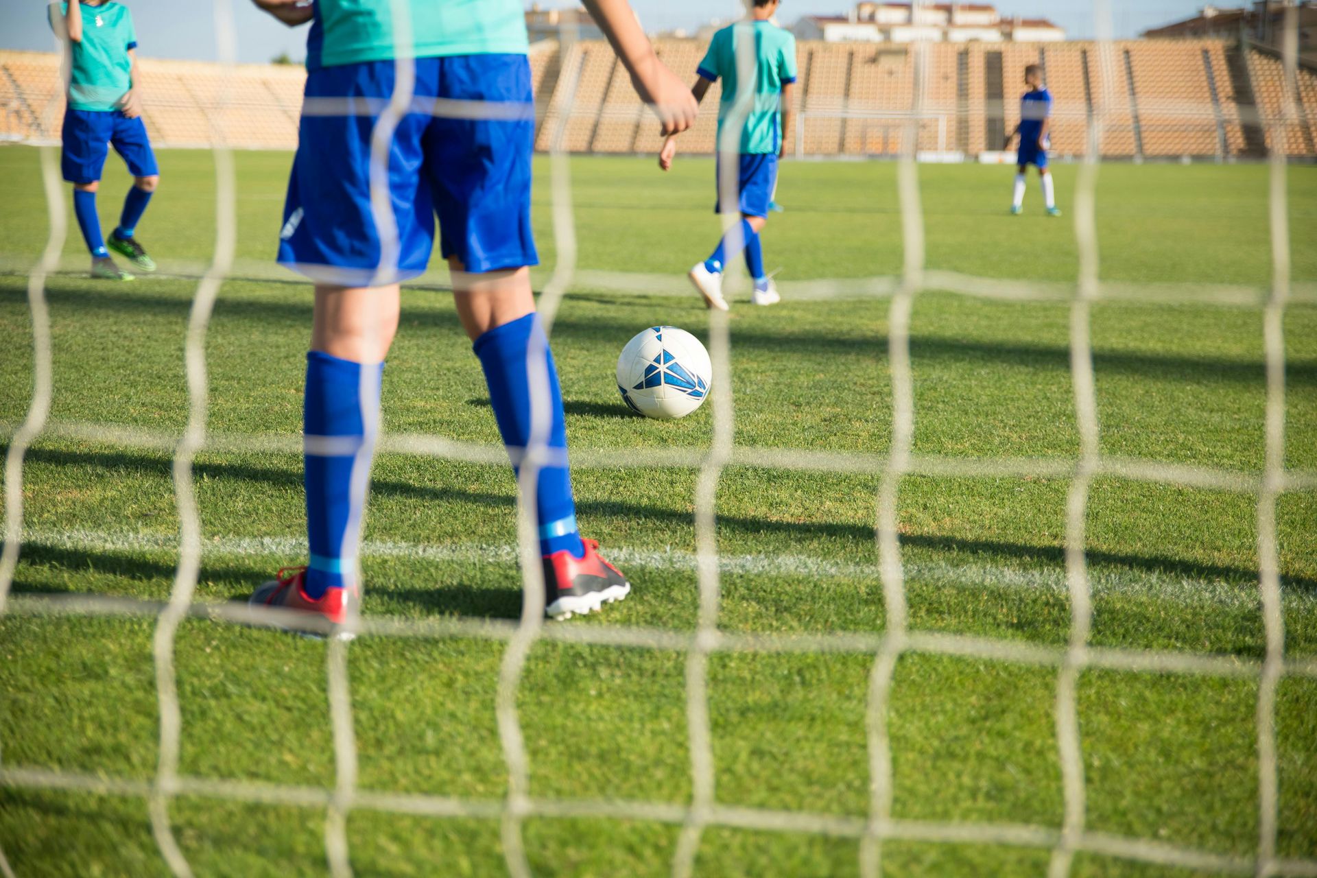 A group of young boys are playing soccer on a field.