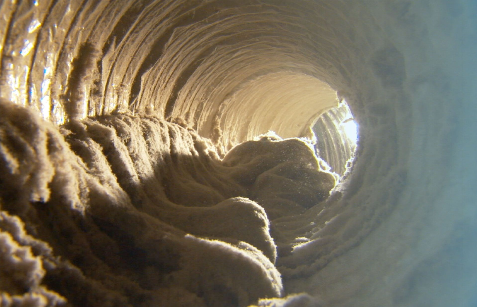 A close up of a tunnel with a light coming out of the end