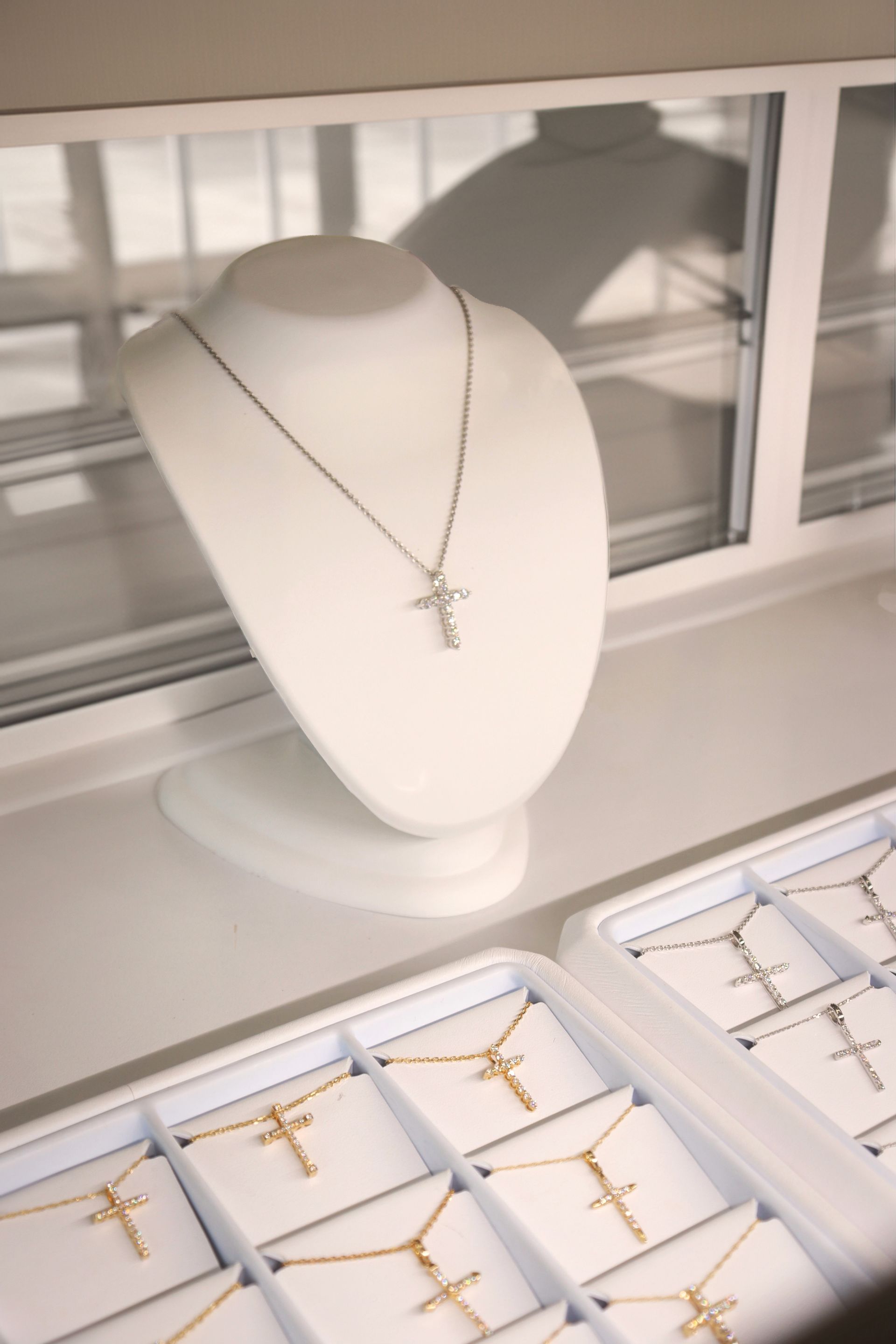 A mannequin with a cross necklace on it