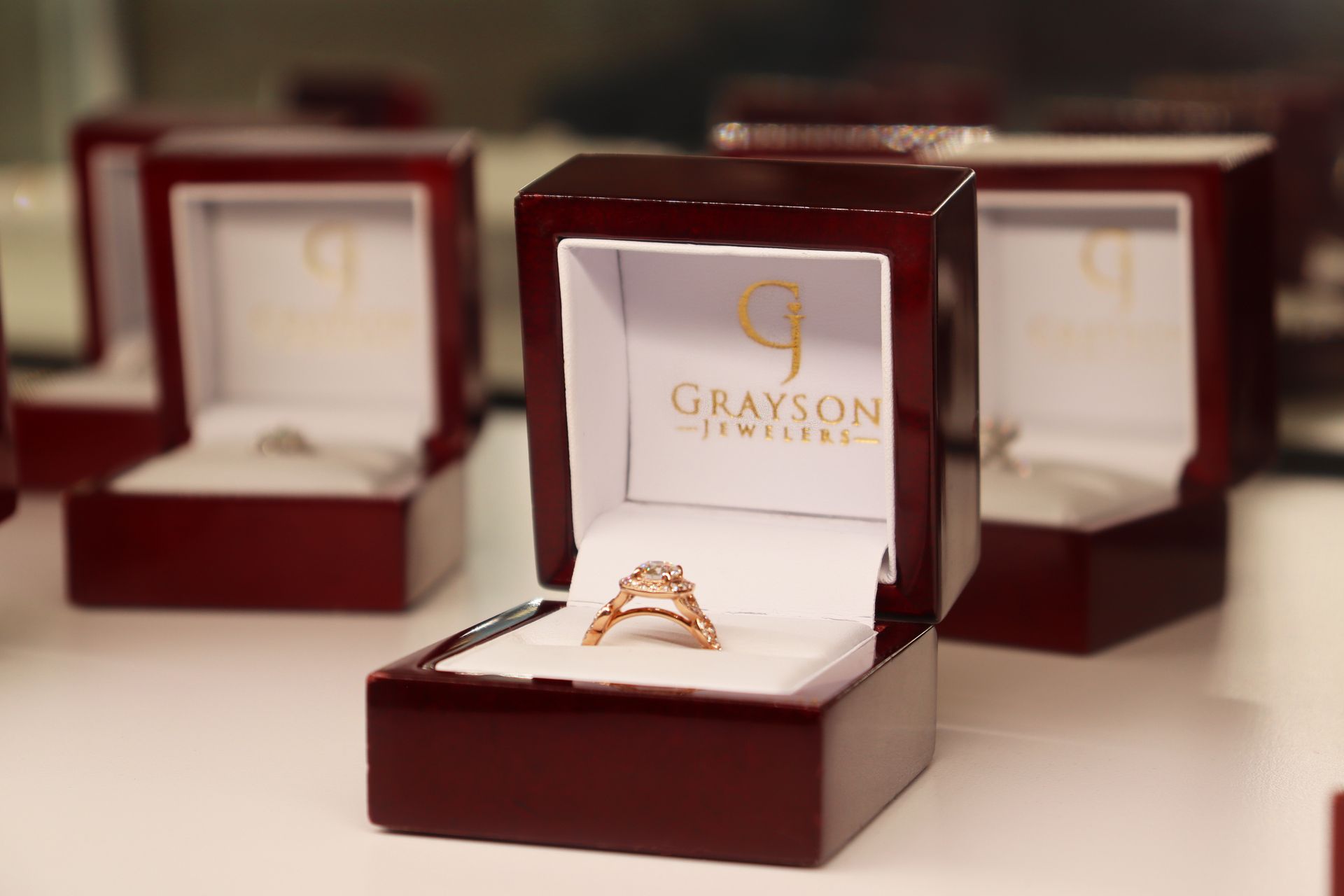 A grayson jewelry box with a ring in it