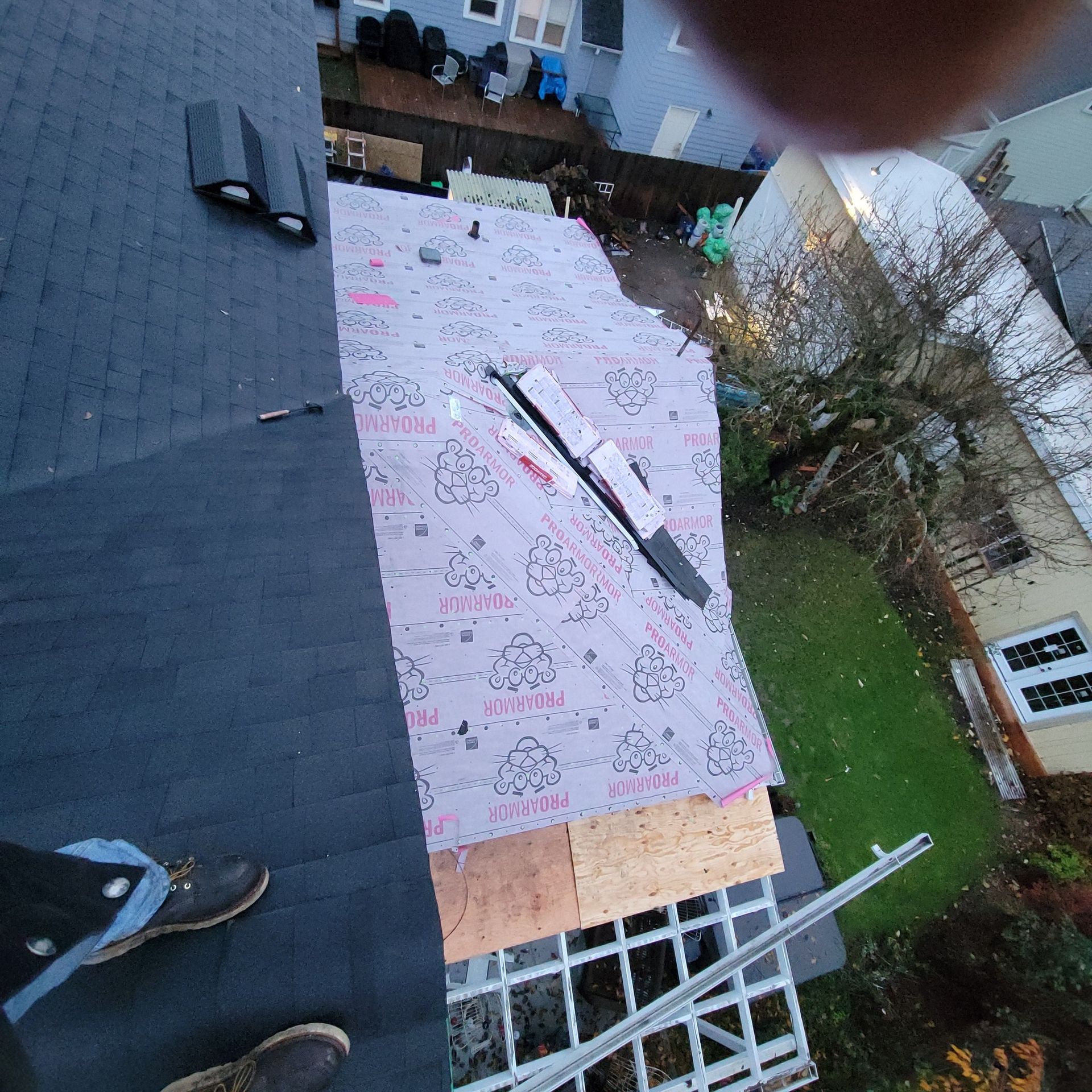An aerial view of a roof that is being repaired
