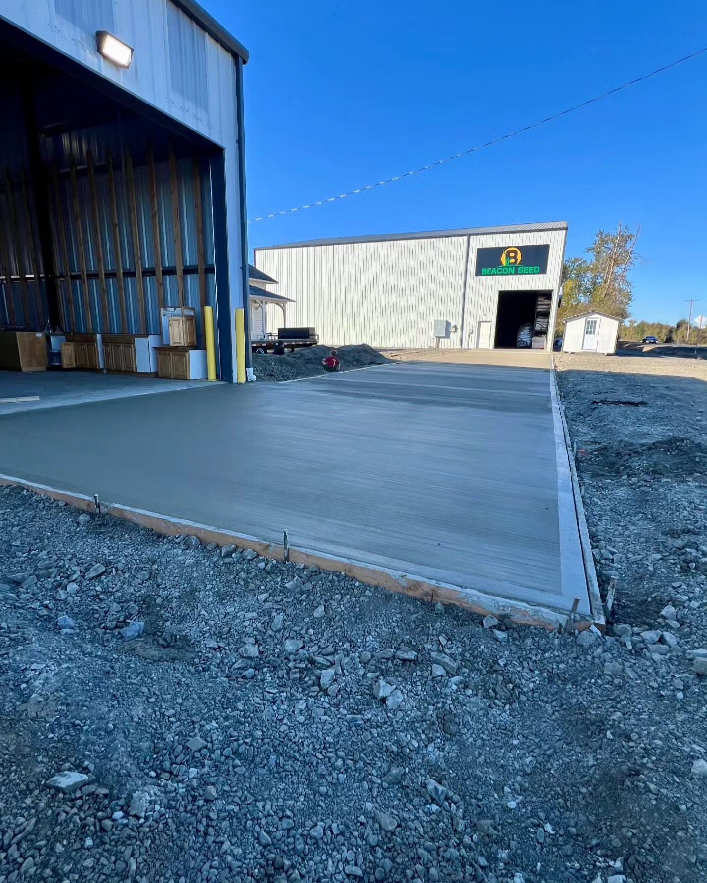 A concrete driveway is being built in front of a building.