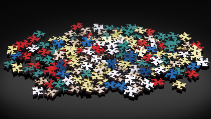 A pile of colorful puzzle pieces on a black surface