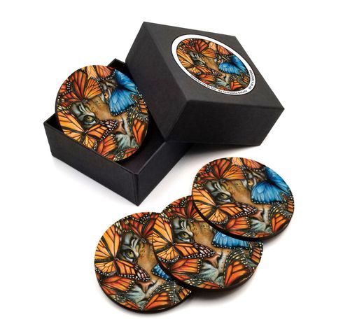 A set of four coasters in a box with butterflies on them