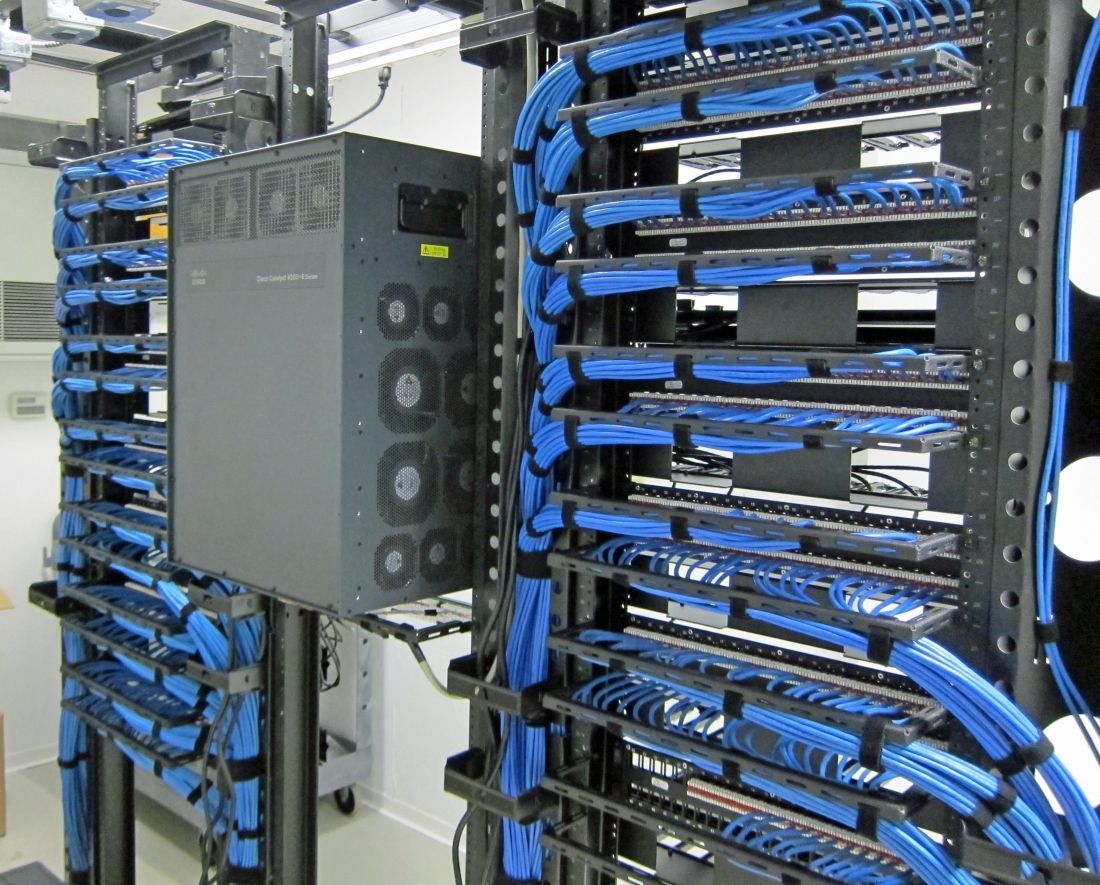 A server rack with lots of blue wires coming out of it
