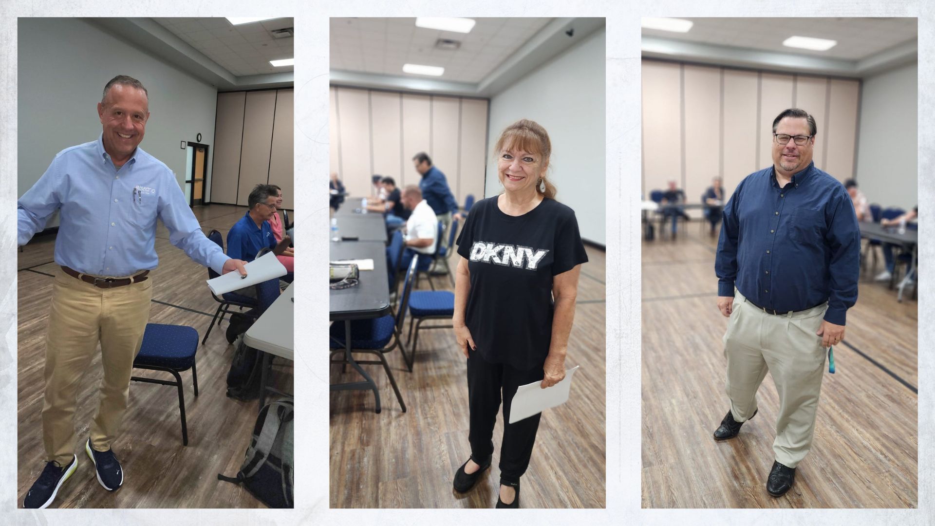 Three people in a room, holding papers. Man in blue shirt, woman in DKNY shirt, man in navy shirt.