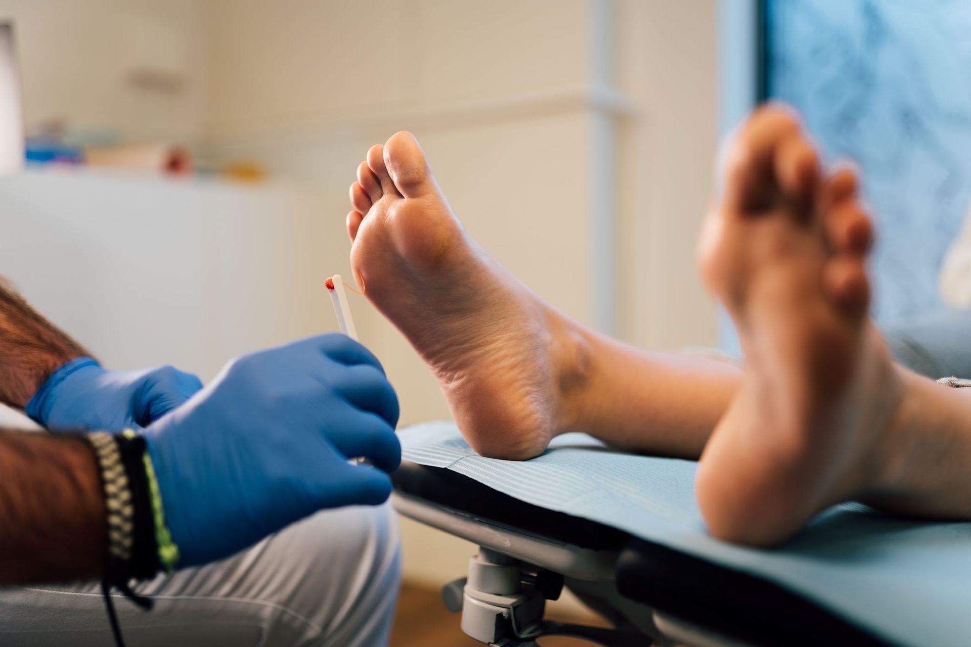 A Doctor is Examining a Patient's Foot With a Syringe — Maitland Central Podiatry In Maitland NSW