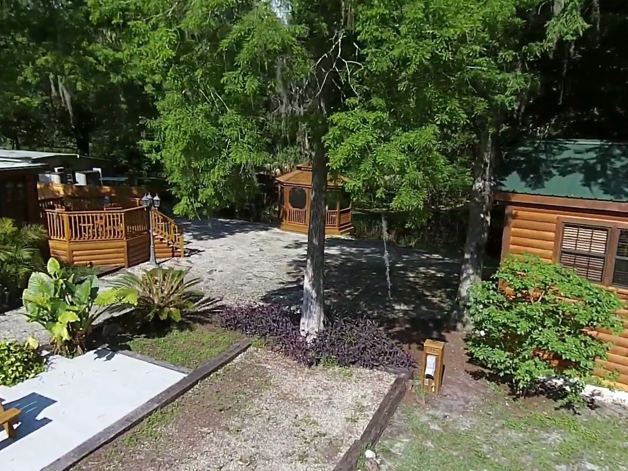 an aerial view of a log cabin surrounded by trees