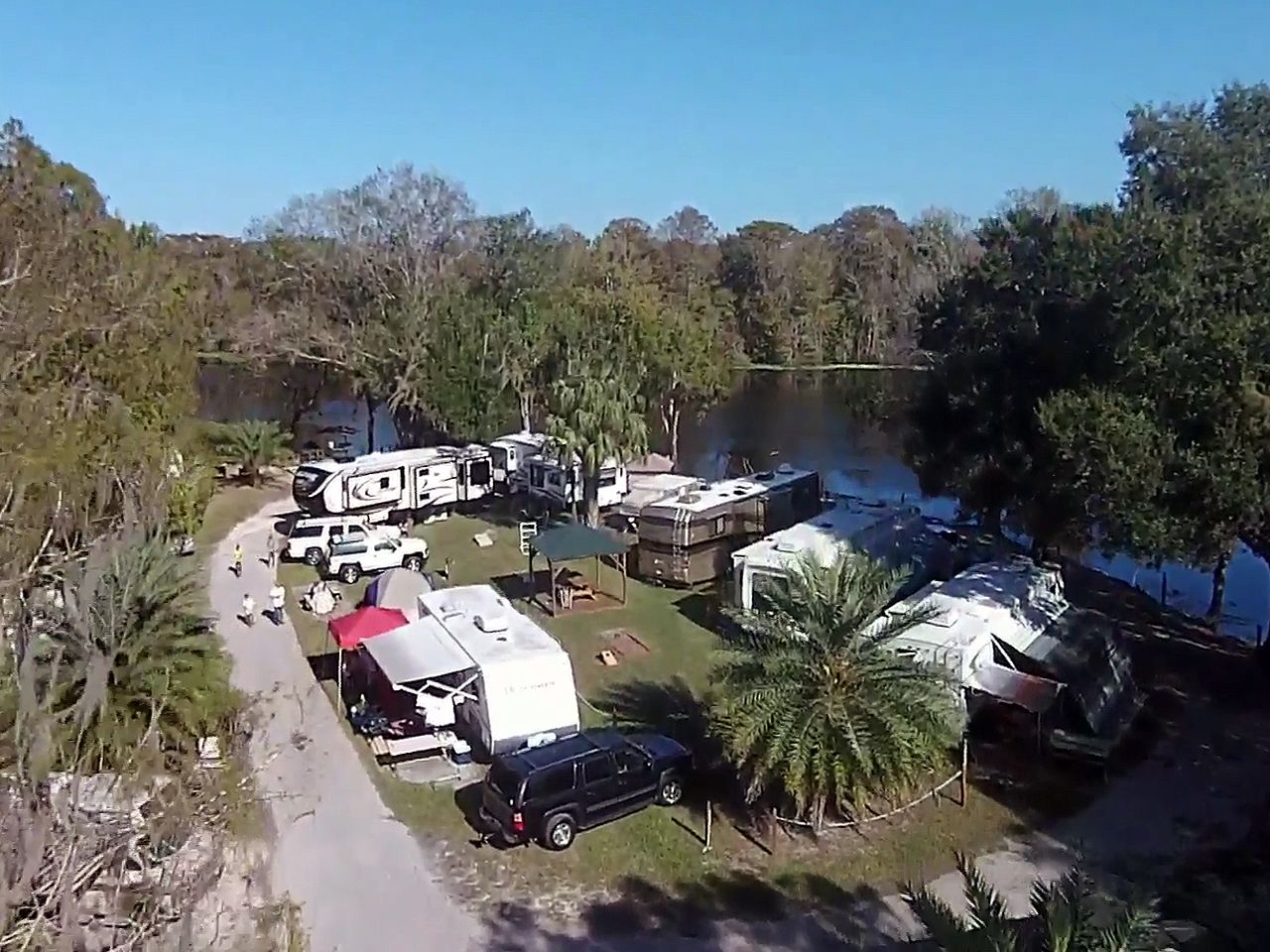 an aerial view of a campground with a lake in the background