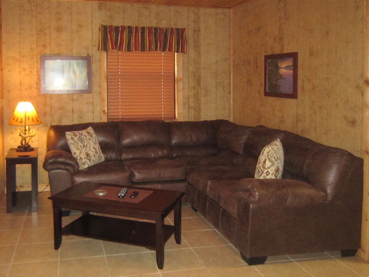 a living room with a sectional couch and a coffee table