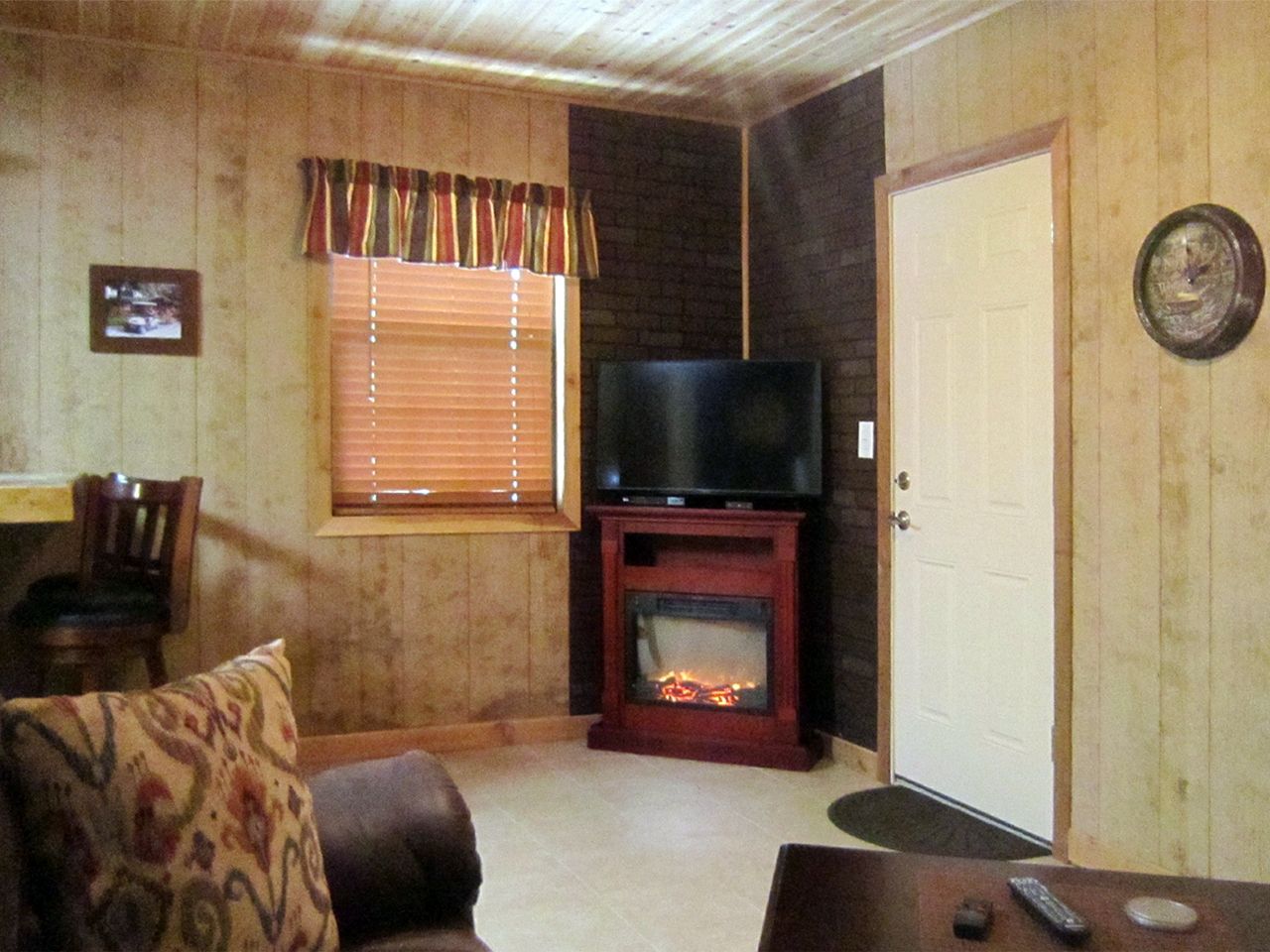 a living room with a fireplace and a flat screen tv