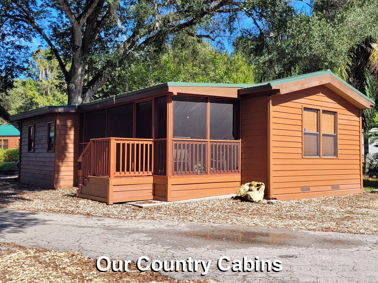 a wooden cabin with a screened in porch and the words our country cabins on the bottom