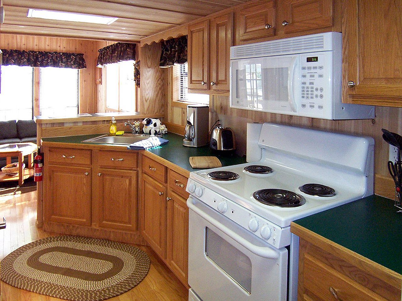 a kitchen with a stove top oven and a microwave