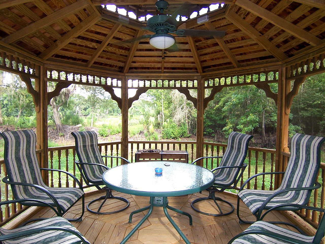 a gazebo with a table and chairs inside of it