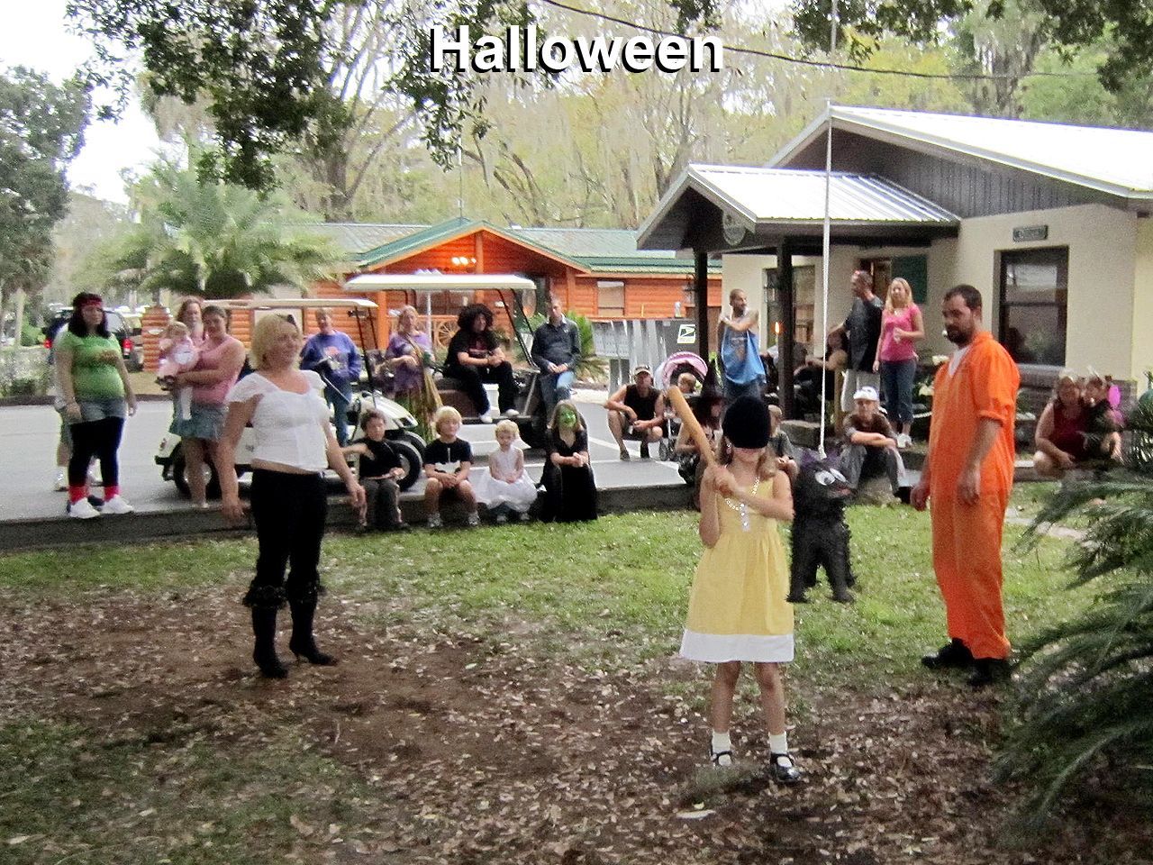 a man in an orange jumpsuit is standing next to a little girl in a yellow dress