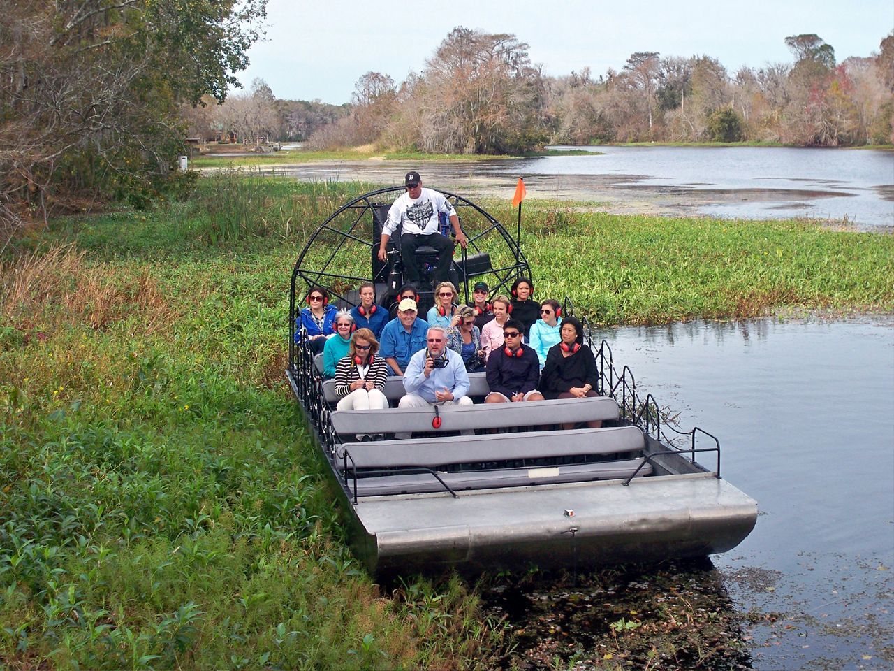 a group of people are riding on a boat in the water .