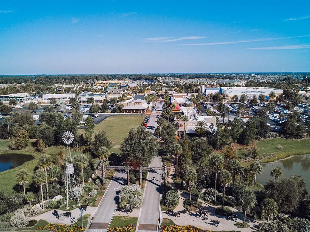 an aerial view of a city surrounded by trees and a lake .
