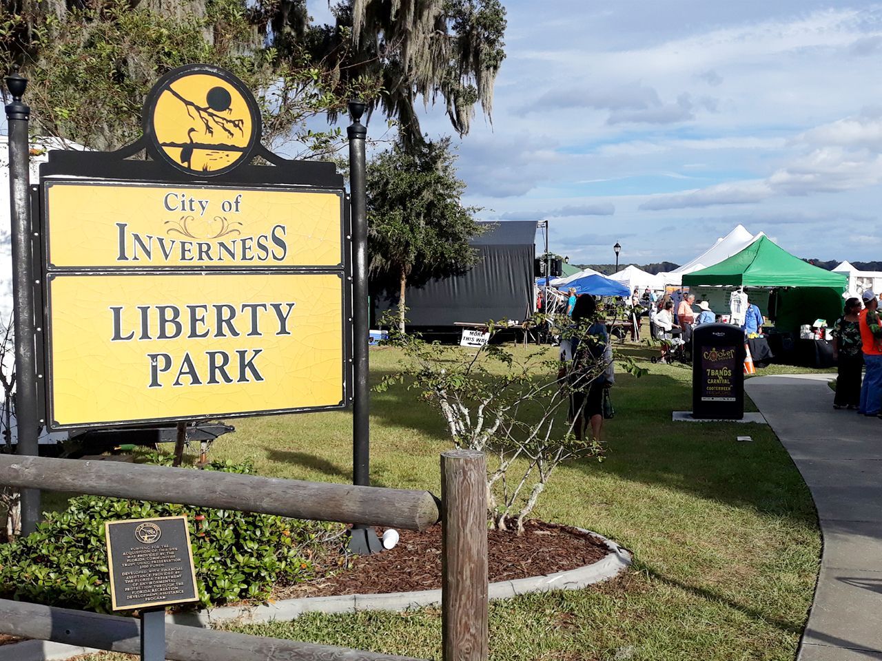 a yellow sign that says city of inverness liberty park
