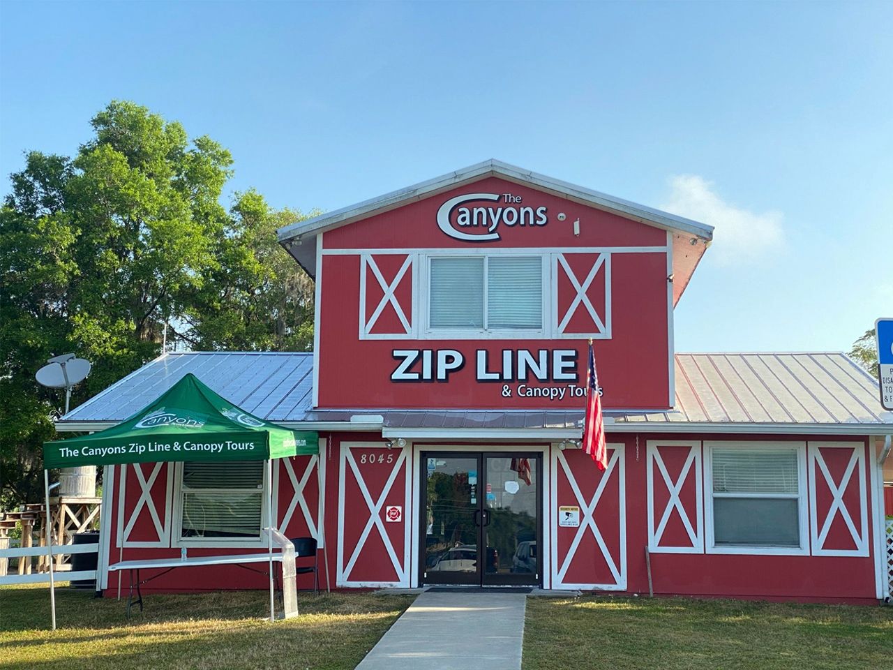 a red building with a sign that says zip line