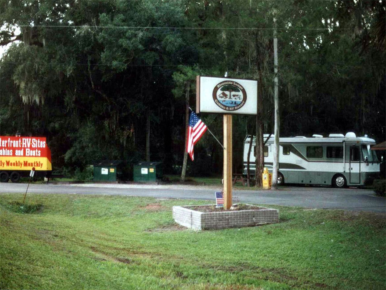 a rv is parked in front of a sign that says drive in