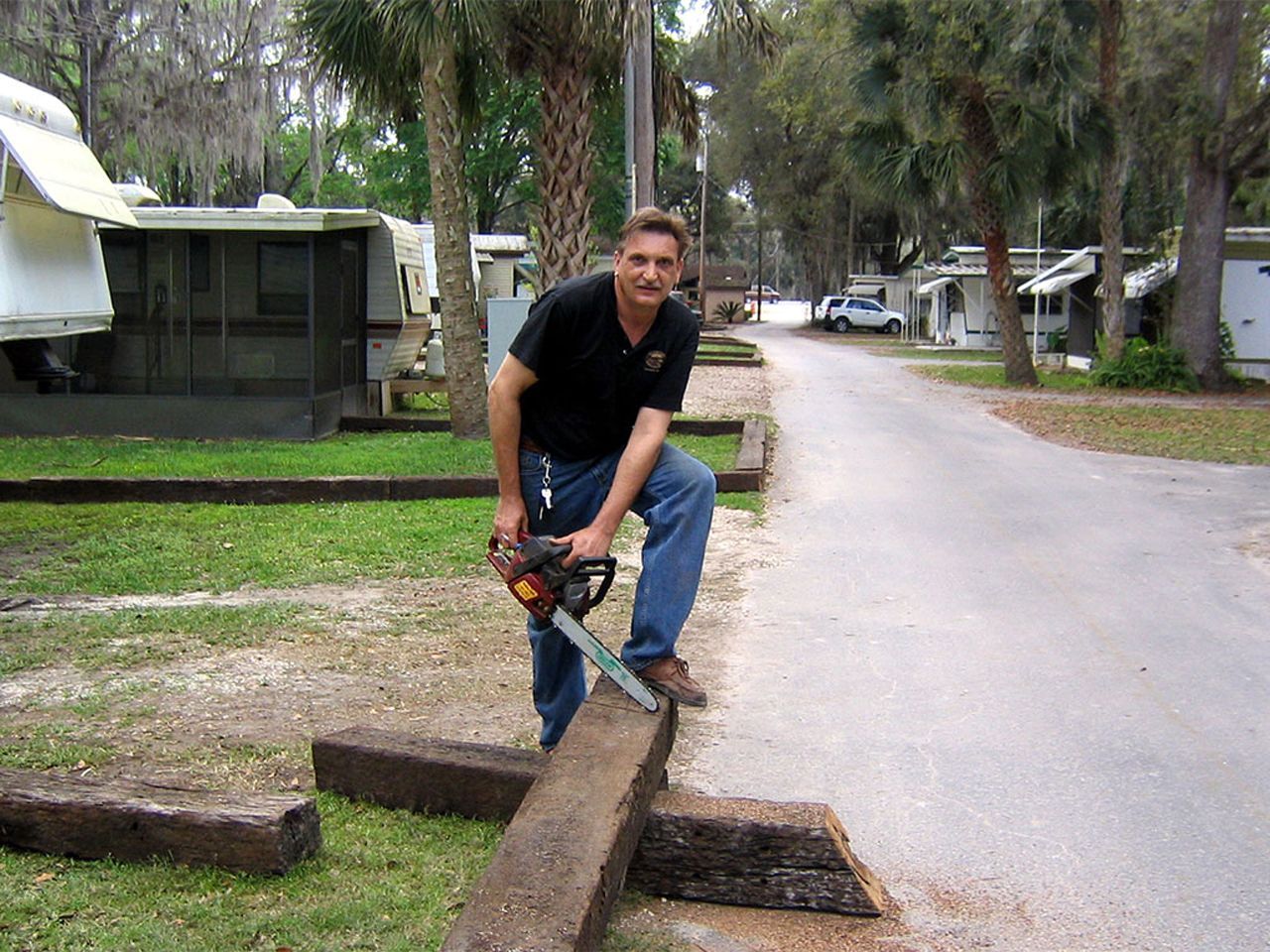 a man is using a chainsaw to cut a log