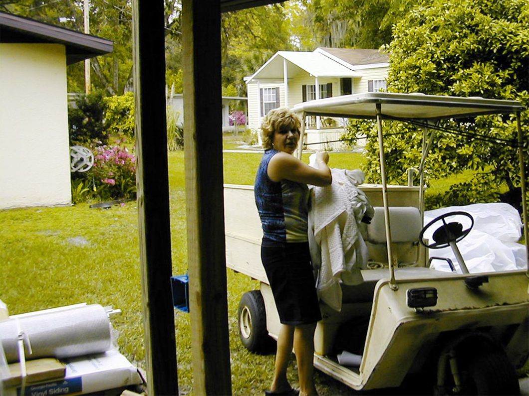 a woman is standing next to a golf cart