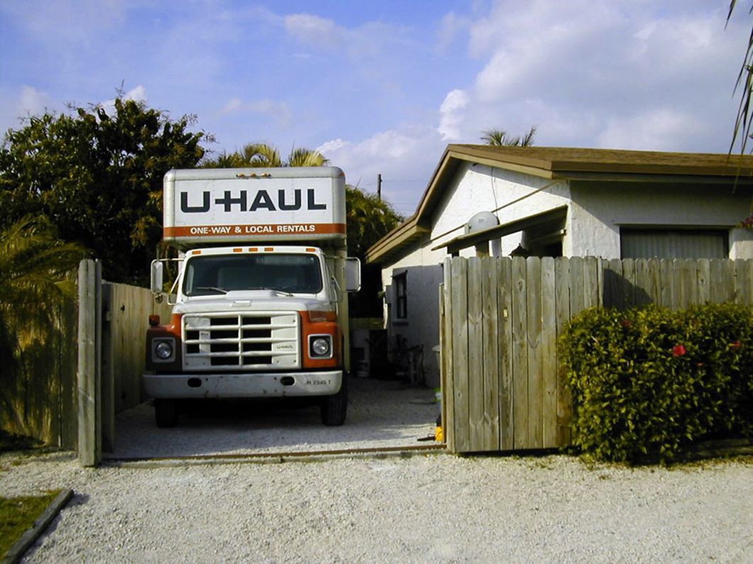 a u-haul truck is parked in front of a house