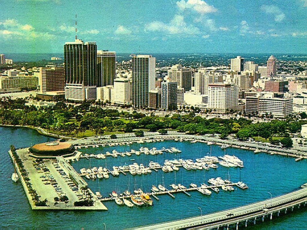 an aerial view of a large body of water with a city in the background