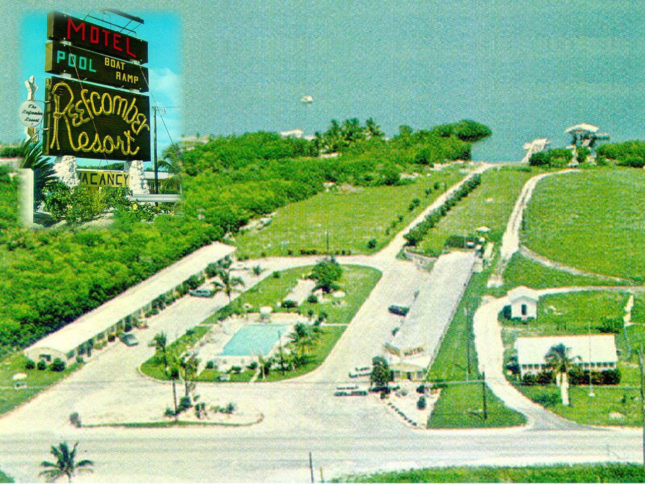 an aerial view of a motel resort with a pool