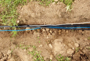 Cables on earth before the trenching process begins.